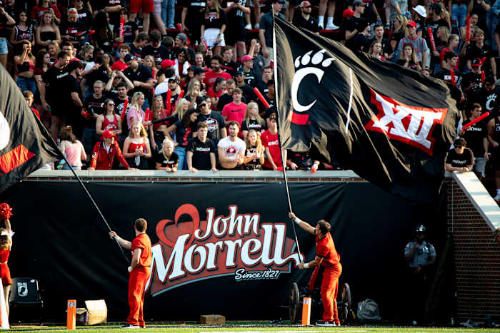 Cincinnati Bearcats Cheerleaders waive flags with the Big 12 logo in the second half of the NCAA football game between Cincinnati Bearcats and Murray State Racers on Saturday, Sept. 11, 2021, at Nippert Stadium in Cincinnati.